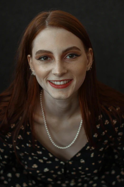 a woman with long red hair smiling at the camera, inspired by Elsa Bleda, androgynous face, real pearls, on clear background, photograph taken in 2 0 2 0