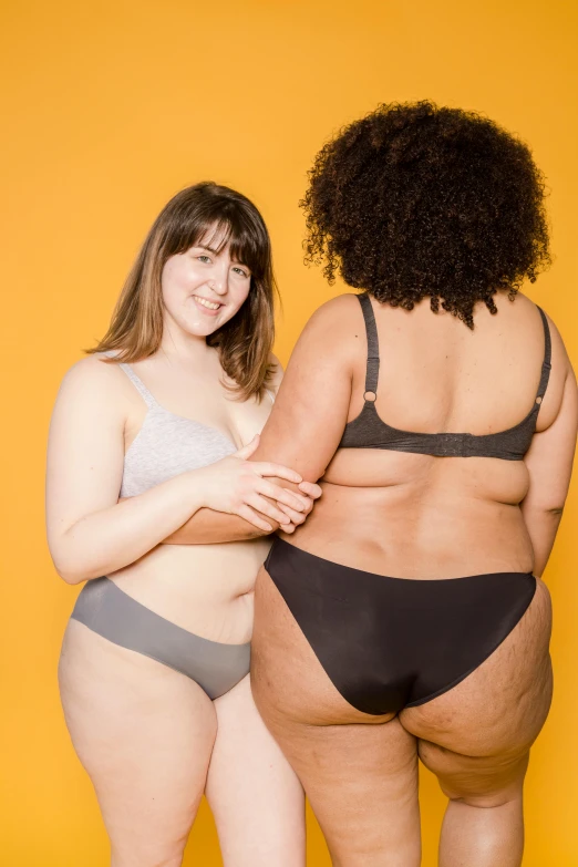 a couple of women standing next to each other, by Arabella Rankin, buttshape, product introduction photo, thicc, gray skin