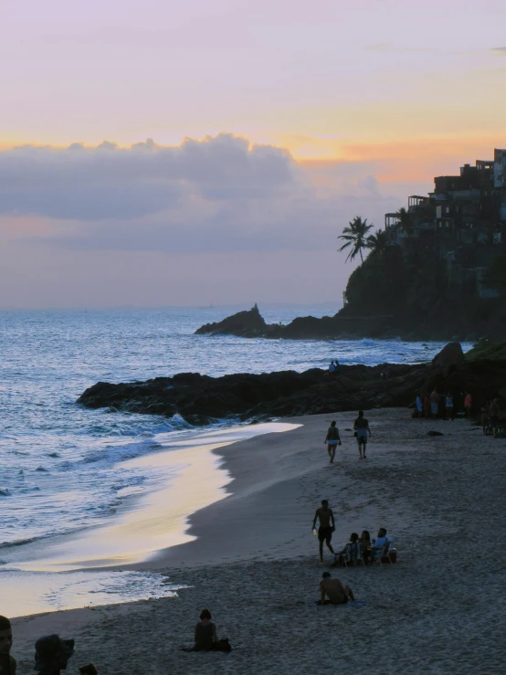 a group of people standing on top of a sandy beach, at the sunset, cliffside town, beach and tropical vegetation, profile image