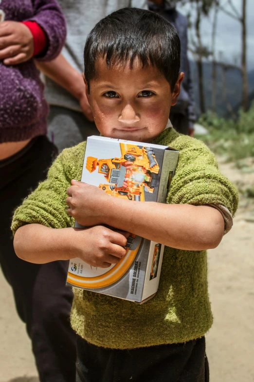 a young boy holding a book in his hands, quito school, carrying survival gear, slide show, more intense, cardboard