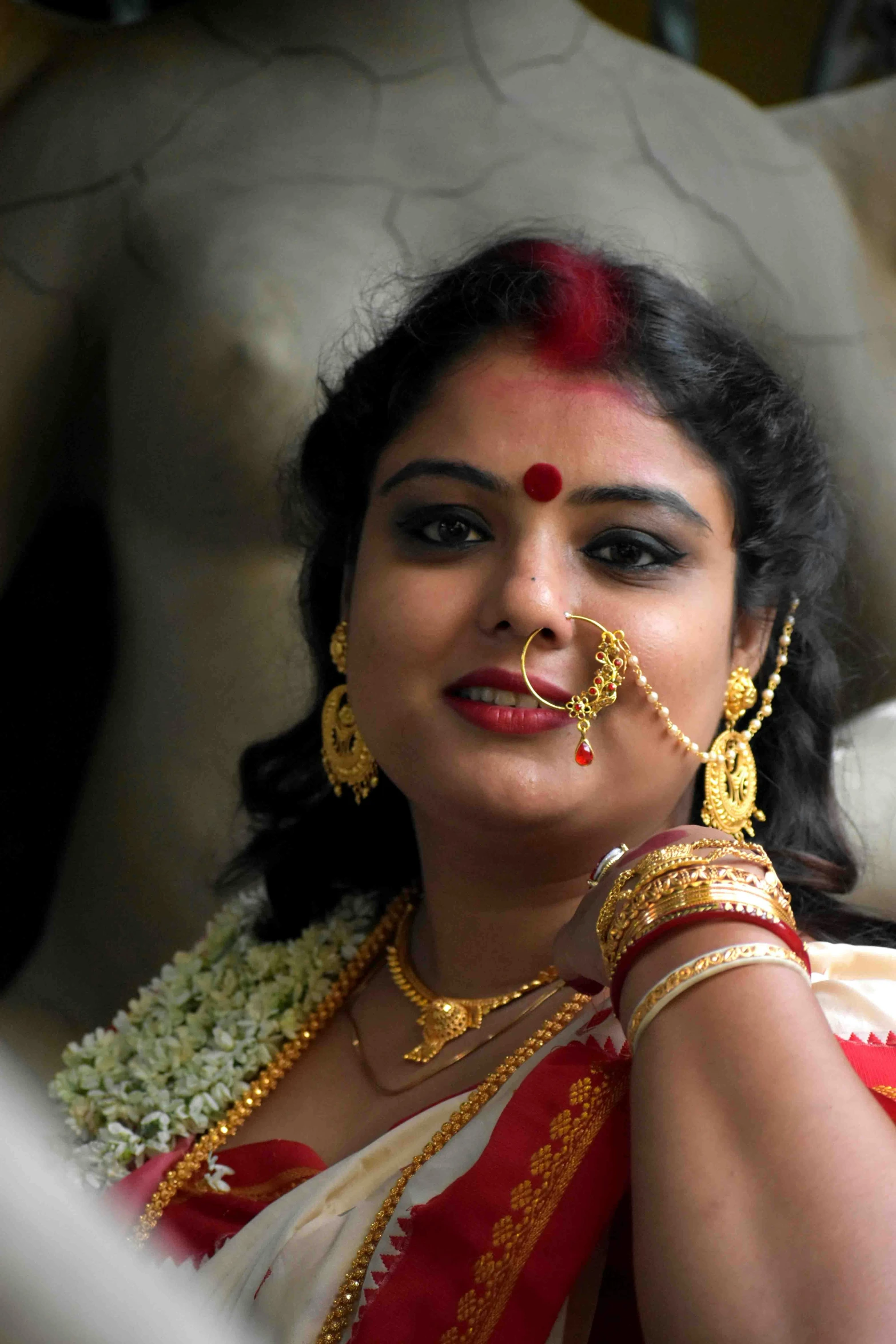 a woman in a red and white sari, an album cover, by Sudip Roy, flickr, wearing gold jewellery, narasimha, photograph credit: ap, wedding