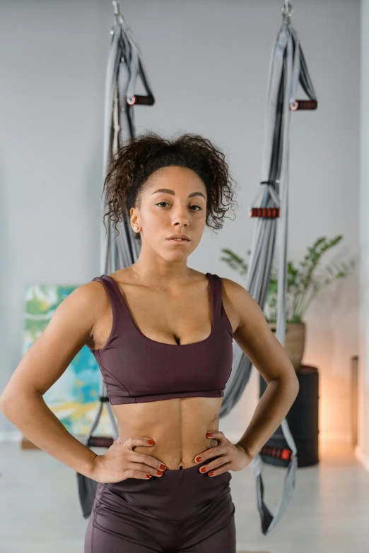 a woman standing on a hammock with her hands on her hips, a portrait, by Washington Allston, trending on pexels, wearing fitness gear, modeling studio, worried, ashteroth