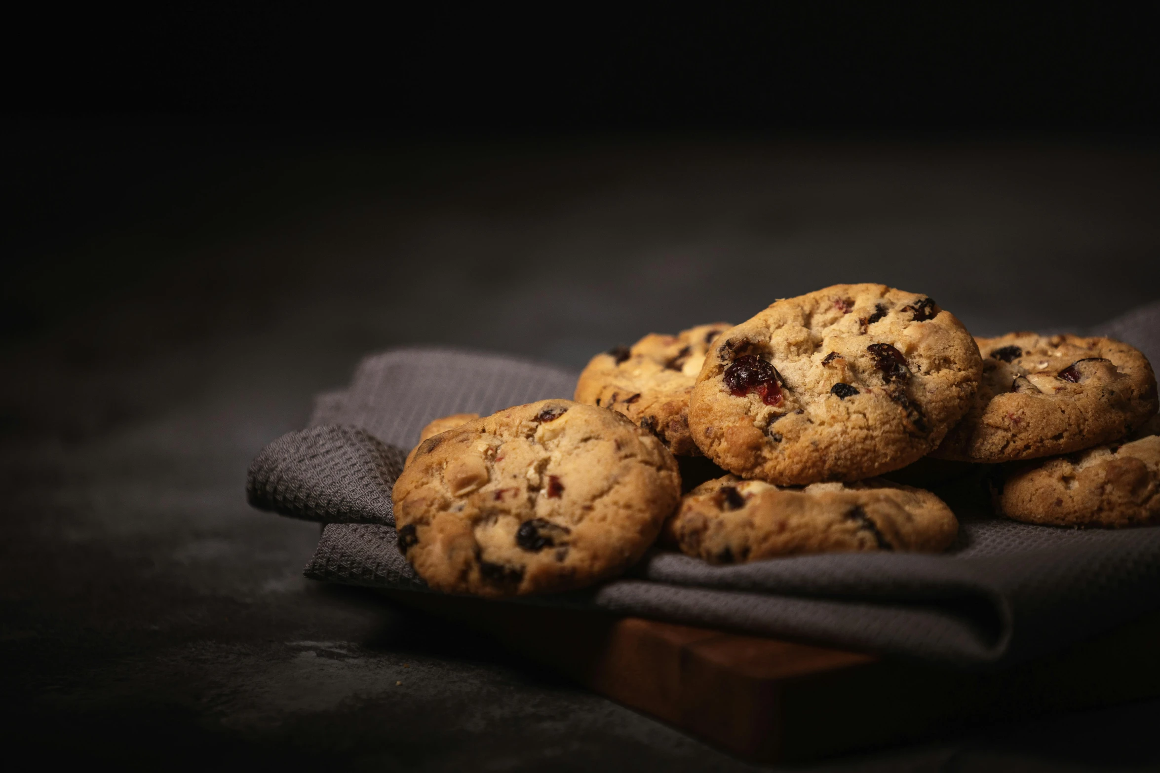 a pile of cookies sitting on top of a cloth, a still life, by Andries Stock, unsplash, dark and realistic, background image