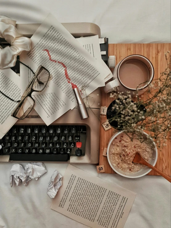 an open laptop computer sitting on top of a bed, by Lucia Peka, trending on unsplash, happening, scattered props, curled up on a book, with square glasses, historical photo