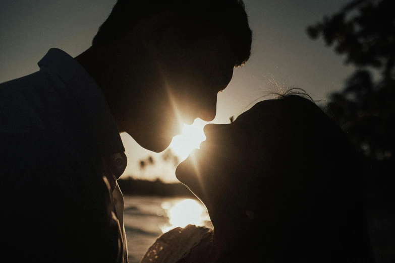 a man and a woman kissing in front of the sun, pexels contest winner, profile image, cinematic footage, good lighted photo, close up photograph