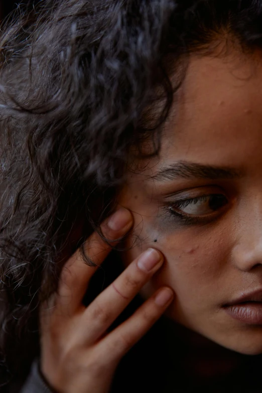 a close up of a person talking on a cell phone, by artist, trending on pexels, renaissance, black scars on her face, portrait rugged girl, young himalayan woman, scarred eye