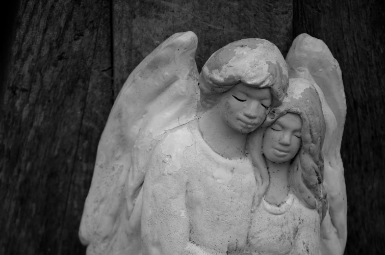 a statue of an angel holding a child, a black and white photo, by Linda Sutton, concrete art, lovers, monochrome 3 d model, mourning family, clay model