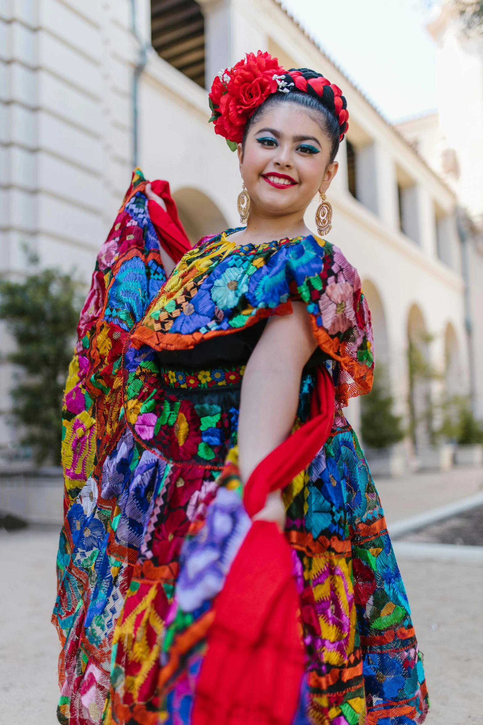 a woman in a colorful dress posing for a picture, inspired by Frida Kahlo, downtown mexico, promotional photo, college, multiple stories