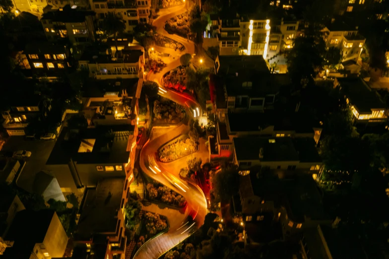 an aerial view of a city at night, by Daniel Lieske, pexels contest winner, process art, long winding stairs going down, mexico, festival. scenic view at night, mulholland drive