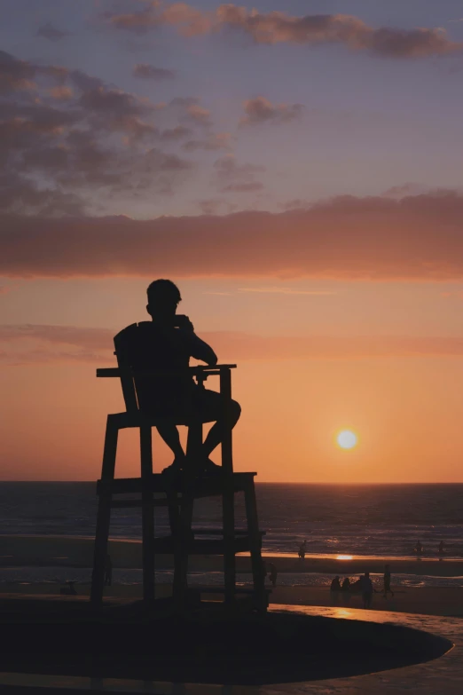 a man sitting in a lifeguard chair on the beach, by Robbie Trevino, pexels contest winner, ((sunset)), # nofilter, profile image, multiple stories