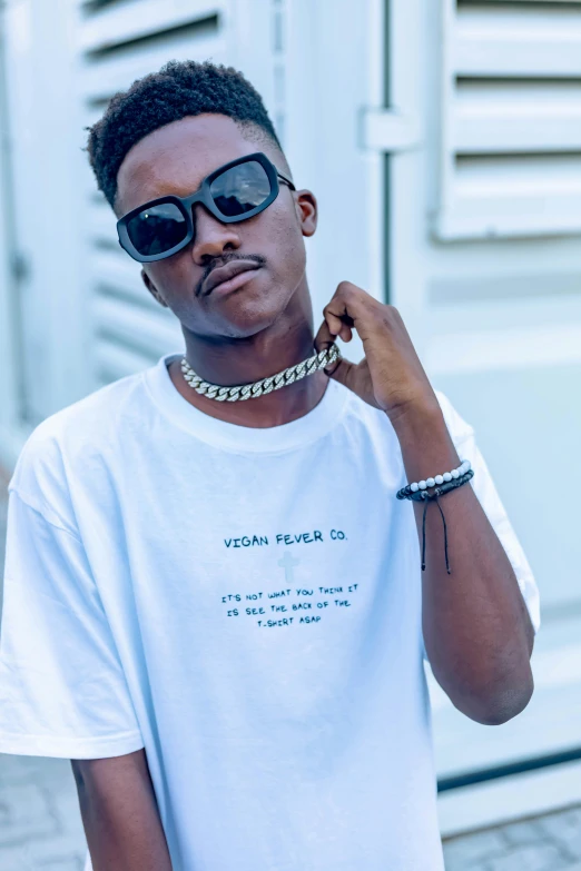 a man with a chain around his neck, an album cover, trending on pexels, trending on r/streetwear, wearing shades, ( ( dark skin ) ), yan gisuka