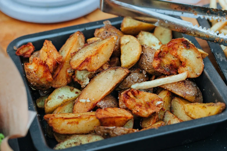 a close up of a tray of food on a table, by Julia Pishtar, potatoes, fan favorite, crisp image