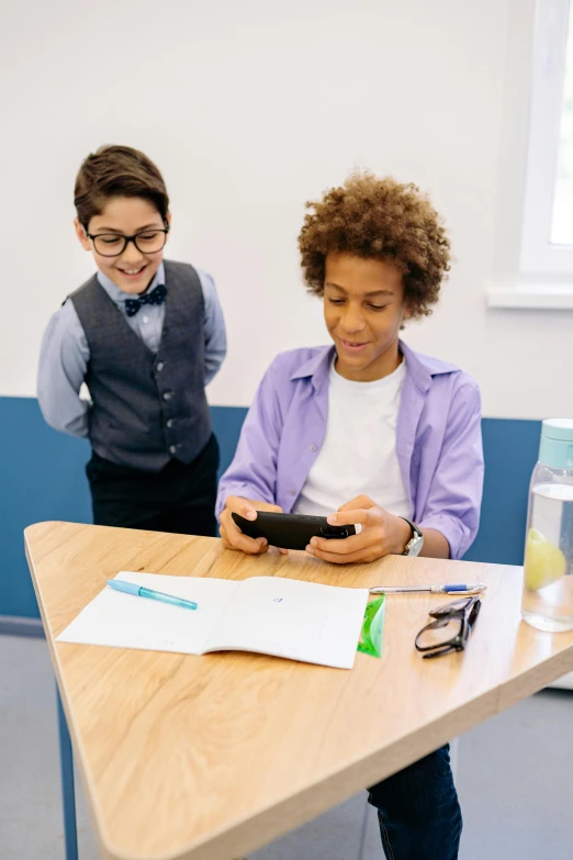 a couple of people that are sitting at a table, trending on pexels, heidelberg school, cute boys, standing on a desk, mobile game, getty images