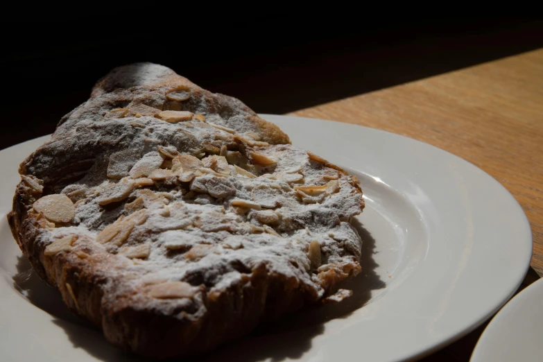 a close up of a plate of food on a table, by Tom Bonson, hurufiyya, bakery, giorno giovanna, profile image, covered in white flour