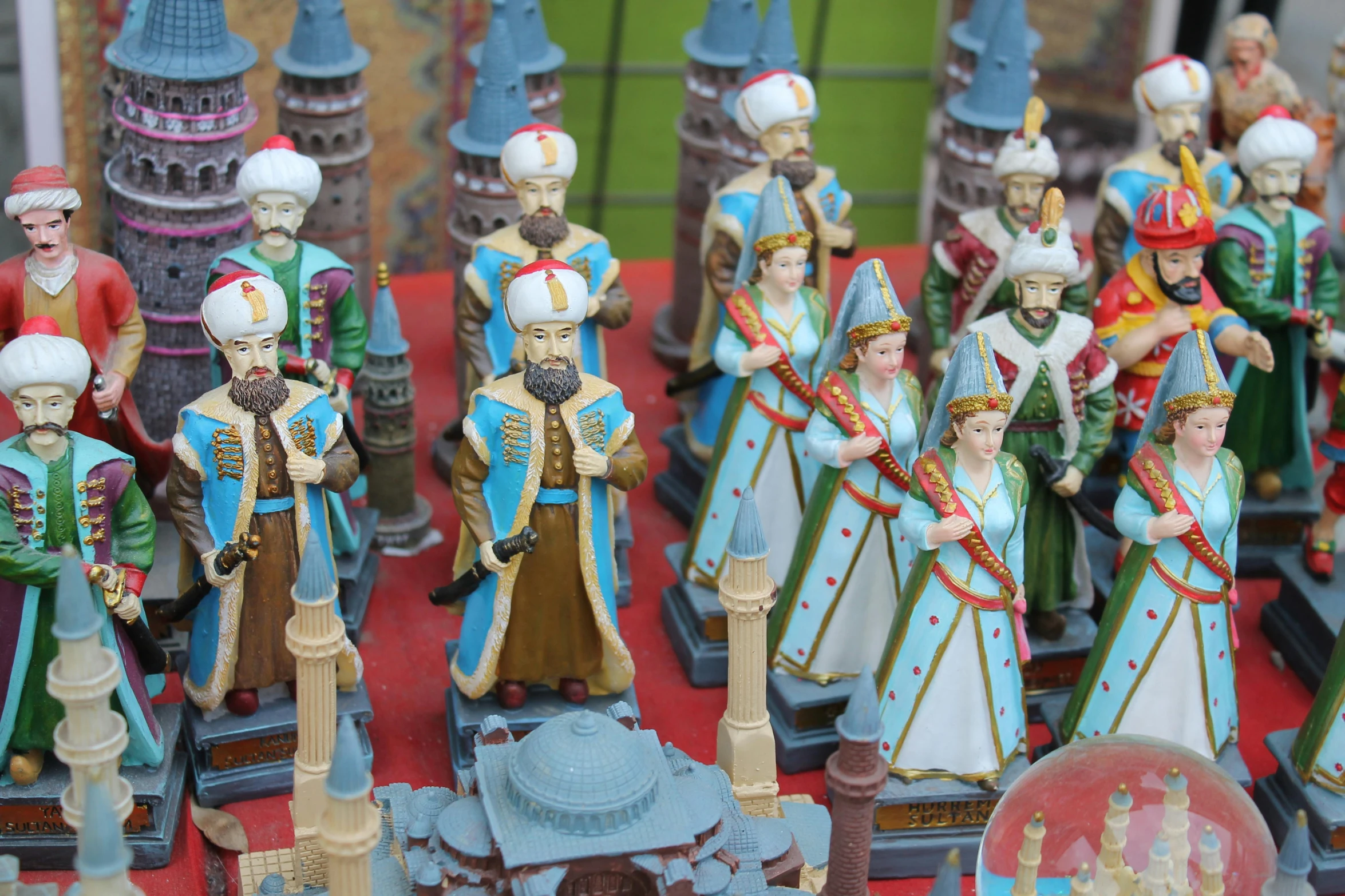 a group of figurines sitting on top of a table, pexels, qajar art, spires, blue, square, middle eastern style vendors