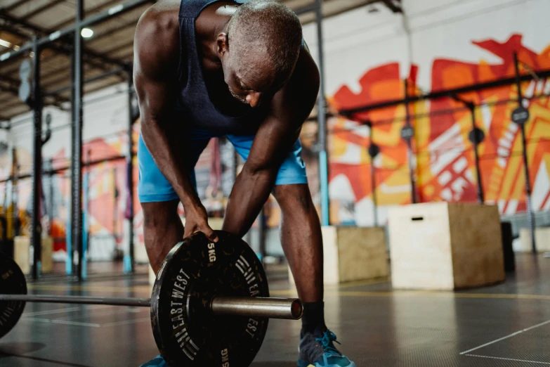 a man lifting a barbell in a gym, pexels contest winner, emmanuel shiru, recovering from pain, avatar image, lachlan bailey