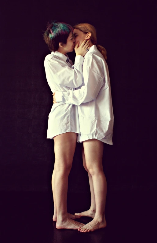 a couple of women standing next to each other, an album cover, unsplash, antipodeans, lesbian kiss, wearing lab coat and a blouse, legs intertwined, 15081959 21121991 01012000 4k