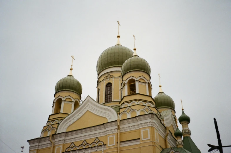 a large building with a clock on top of it, in orthodox church, olive green and venetian red, capital of estonia, atmospheric photograph