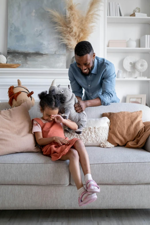 a man and a little girl sitting on a couch, stuffed animal, samsung smartthings, kano), good housekeeping