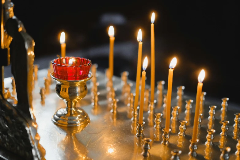 a group of candles sitting on top of a table, orthodoxy, fan favorite, profile image, gold encrustations