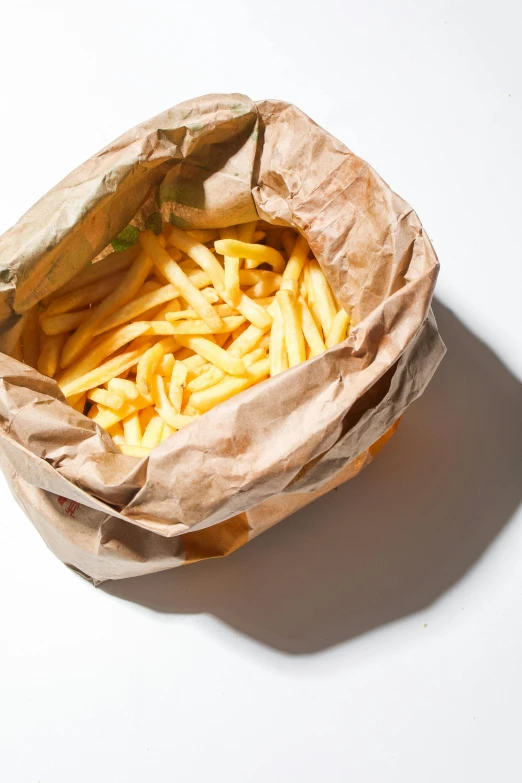 a brown paper bag filled with french fries, unsplash, hyperrealism, no type, (cheese), epicurious, opening