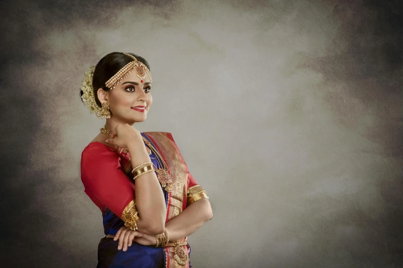 a woman in a sari posing for a picture, inspired by T. K. Padmini, trending on cg society, red blue and gold color scheme, official store photo, commercial photo shoot, studio photoshoot