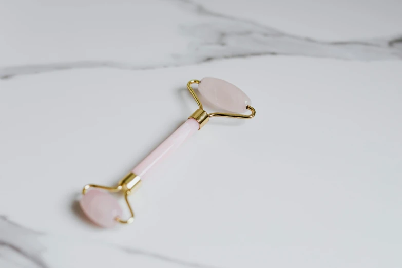 a pink toothbrush sitting on top of a marble counter, by Emma Andijewska, trending on pexels, pink body harness, lie on a golden stone, gemstone forehead, shades