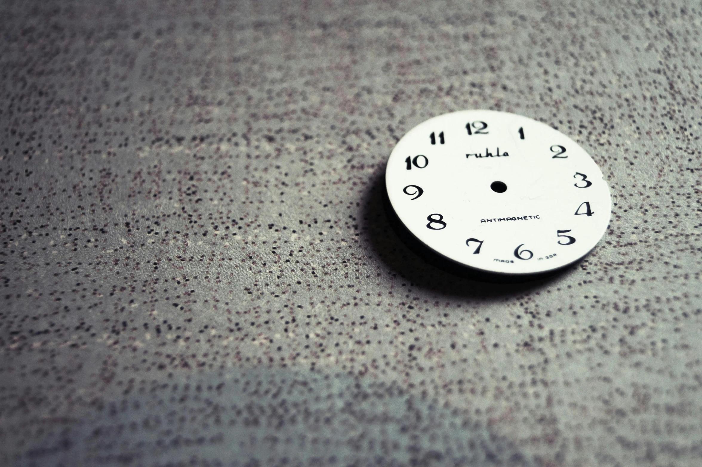 a white clock sitting on top of a table, a photo, by Pablo Rey, rule-of-thirds, huble, fine texture, cute:2