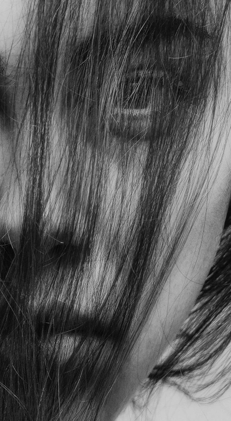 a black and white photo of a woman with long hair, a black and white photo, by Ai-Mitsu, unsplash, skin detail, [ [ hyperrealistic ] ], dynamic closeup, long mane