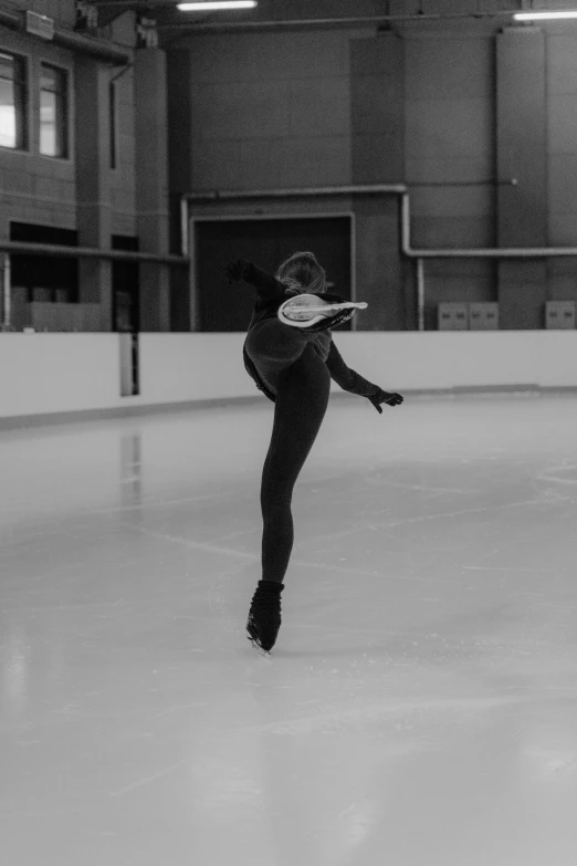 a man riding a skateboard on top of an ice rink, a black and white photo, arabesque, she is floating in the air, wearing a tracksuit, sydney hanson, profile image