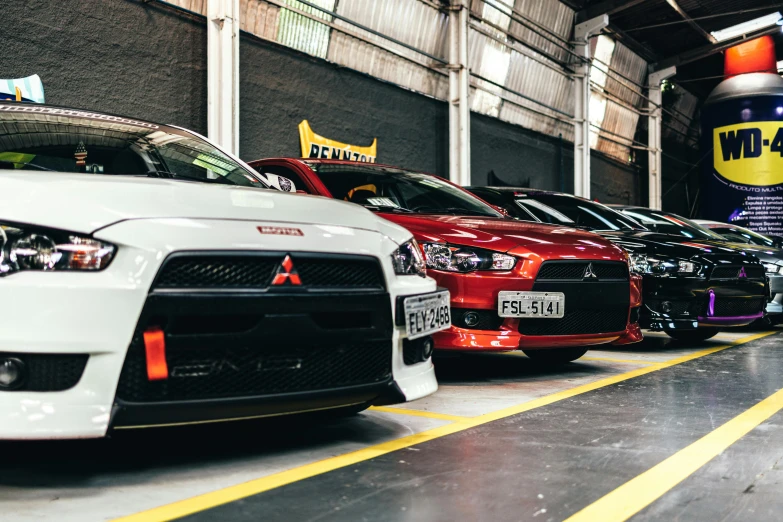 a group of cars parked next to each other in a garage, unsplash, são paulo, japanese drift car, profile image, frontal picture