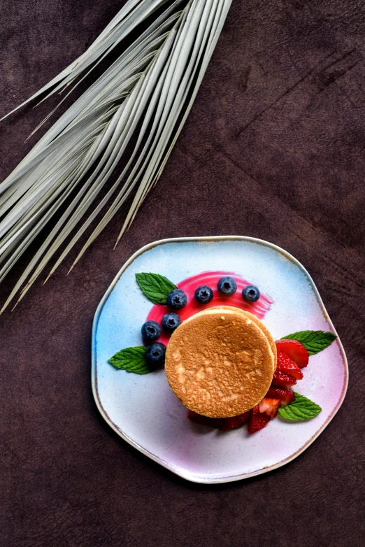 a close up of a plate of food on a table, dessert, product image, botanicals, bronze poli