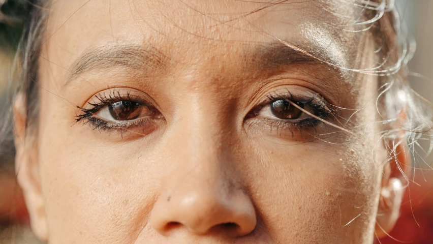 a close up of a woman eating a banana, trending on pexels, hyperrealism, jimin\'s right eyelid swollen, indian girl with brown skin, human with one robot eye, professional closeup photo