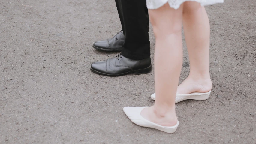 a man and a woman standing next to each other, trending on unsplash, silk shoes, walk in a funeral procession, marriage, different shapes and sizes