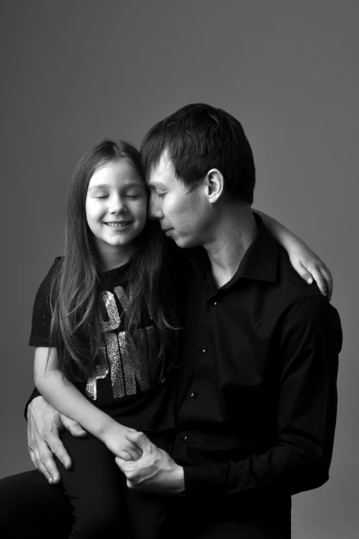 a man and a woman sitting next to each other, a black and white photo, by Winona Nelson, 5 years old, jingna zhang, andrey surnov, dad