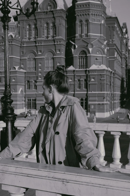 a black and white photo of a woman on a bridge, red square, 1990s photograph, 1987 photograph, looking content