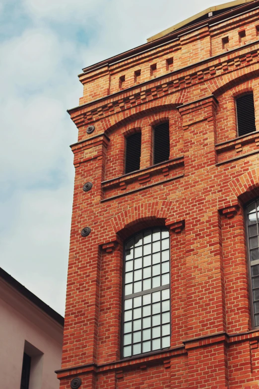 a tall brick building with a clock on top of it, by Adam Marczyński, pexels contest winner, ventilation shafts, profile image, 1910s architecture, lower saxony