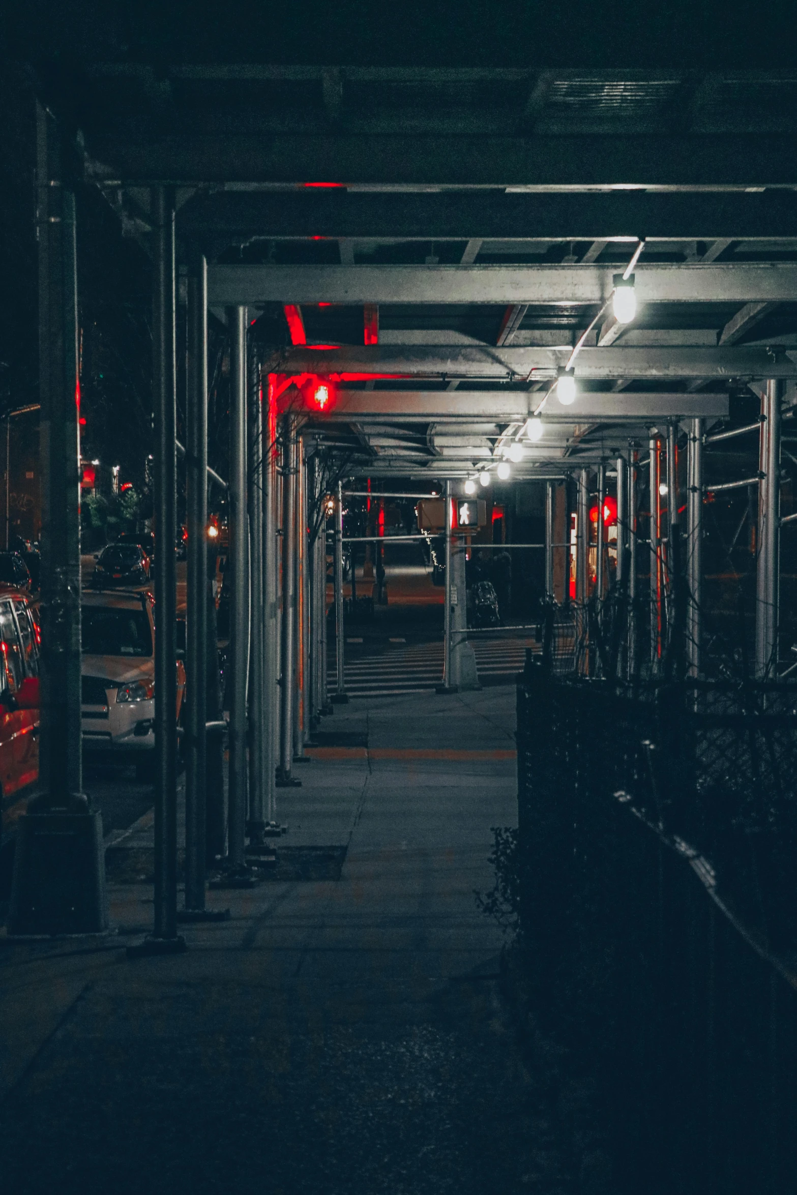 a car parked in a parking garage at night, unsplash contest winner, red lanterns, new york back street, walkway, industrial aesthetic