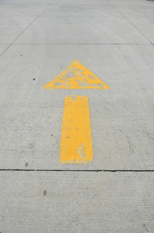 a street with a yellow arrow painted on it, by Michael Sittow, on grey background, upward shot, cone, casey cooke