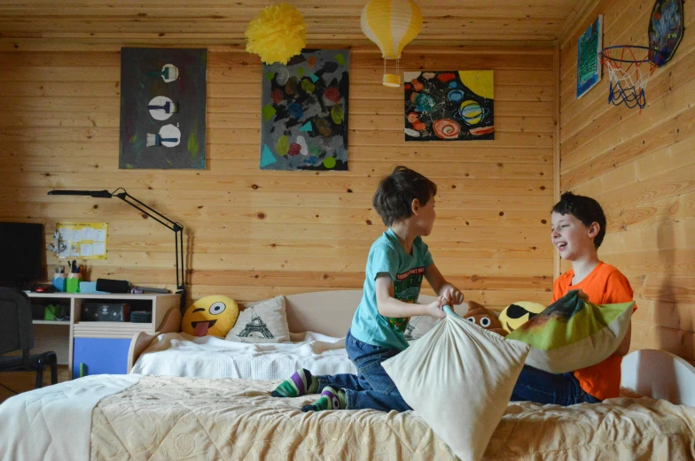 a couple of kids sitting on top of a bed, by Jaakko Mattila, pexels, visual art, boy's room, in a cabin, avatar image