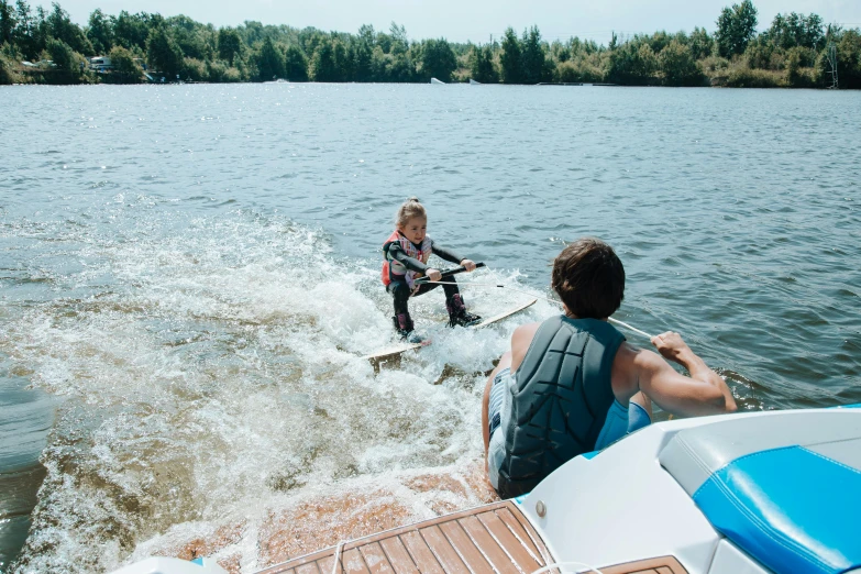 a couple of people riding on the back of a boat, by Jaakko Mattila, pexels contest winner, process art, hoverboard, little kid, quebec, a photo of a lake on a sunny day