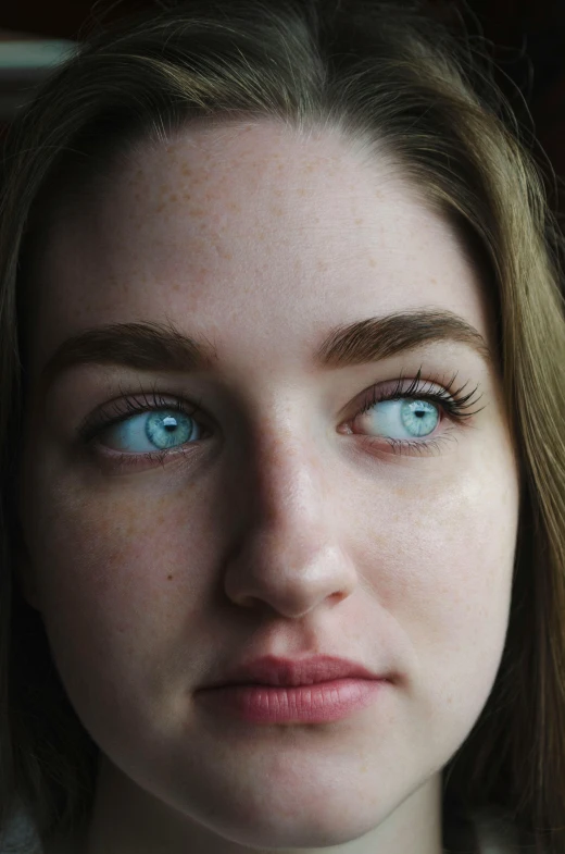 a close up of a person with blue eyes, looking up at the camera, looking away from the camera, hyperrealistic teen, pale glowing skin