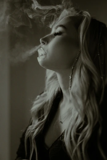 a black and white photo of a woman smoking a cigarette, inspired by Elsa Bleda, unsplash, renaissance, chloe grace moretz, ganja, profile image, still from a music video