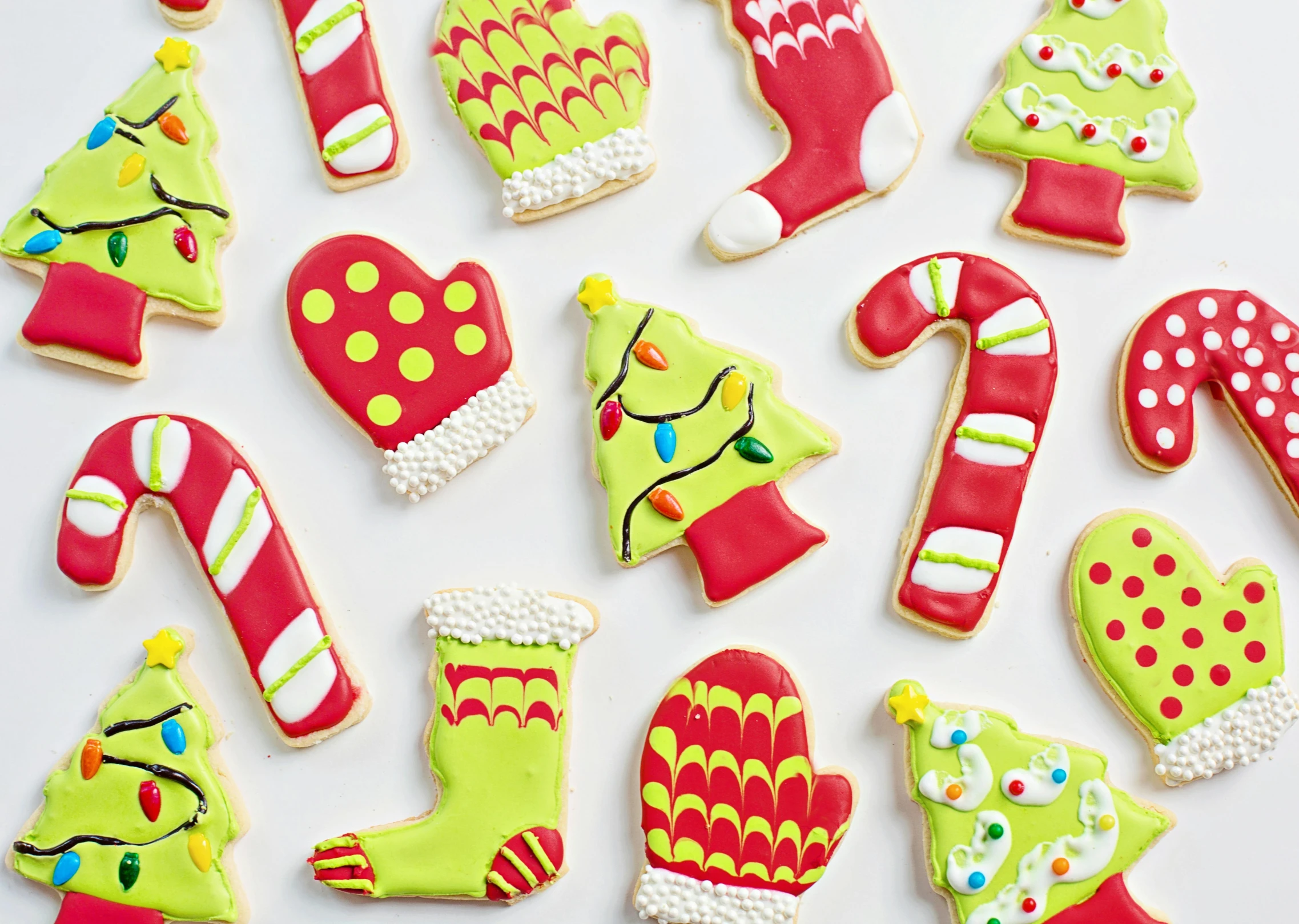 a bunch of decorated cookies sitting on top of a table, by Julia Pishtar, green bright red, mittens, full product shot, lime green