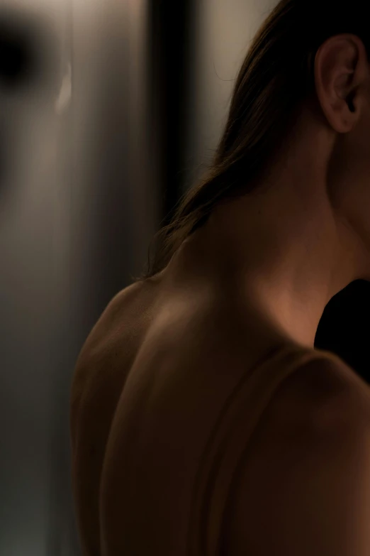 a woman brushing her teeth in front of a mirror, by Alexander Mann, trending on unsplash, digital art, showing her shoulder from back, sensual lighting, bare back, brown hair in a ponytail