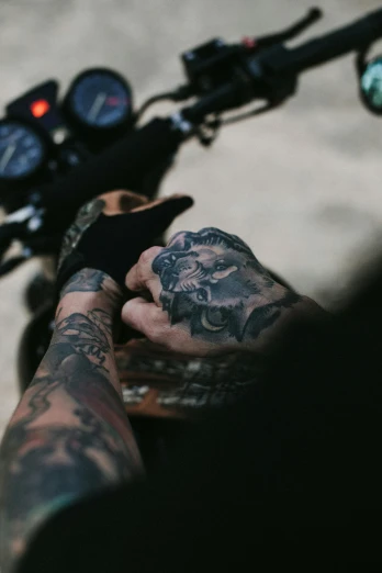 a close up of a person on a motorcycle, a tattoo, trending on pexels, hands shielding face, black veins, uploaded, 1 2 9 7