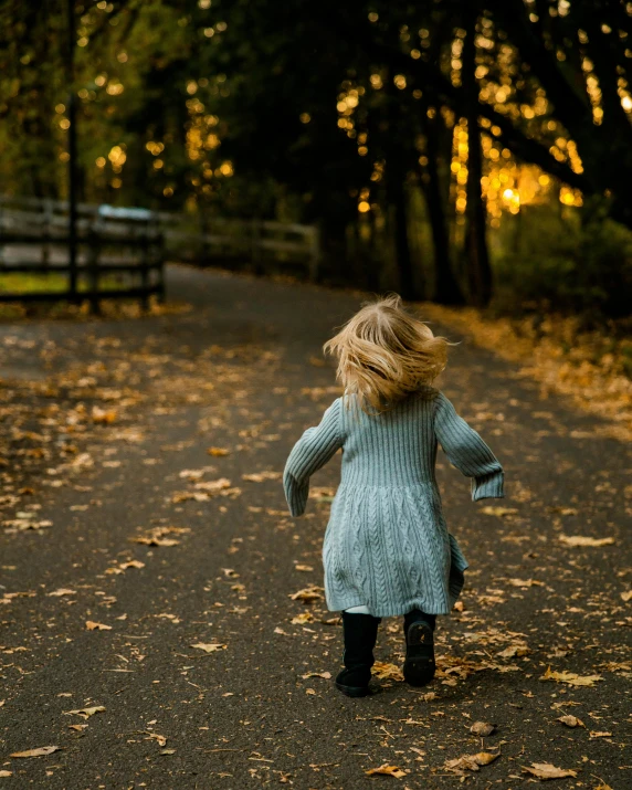 a little girl that is walking down a path, by Maggie Hamilton, pexels contest winner, melancholy autumn light, wavy hair spread out, 15081959 21121991 01012000 4k, she is dancing