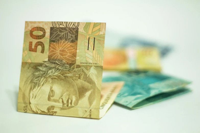 a pile of money sitting on top of a table, brazilian, thumbnail, niea 7, new zealand