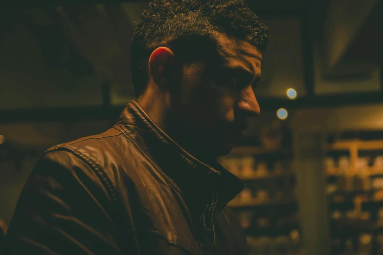 a man in a leather jacket looking at a cell phone, pexels contest winner, renaissance, standing in a dimly lit room, portrait of danny gonzalez, profile picture 1024px, scene from fightclub movie