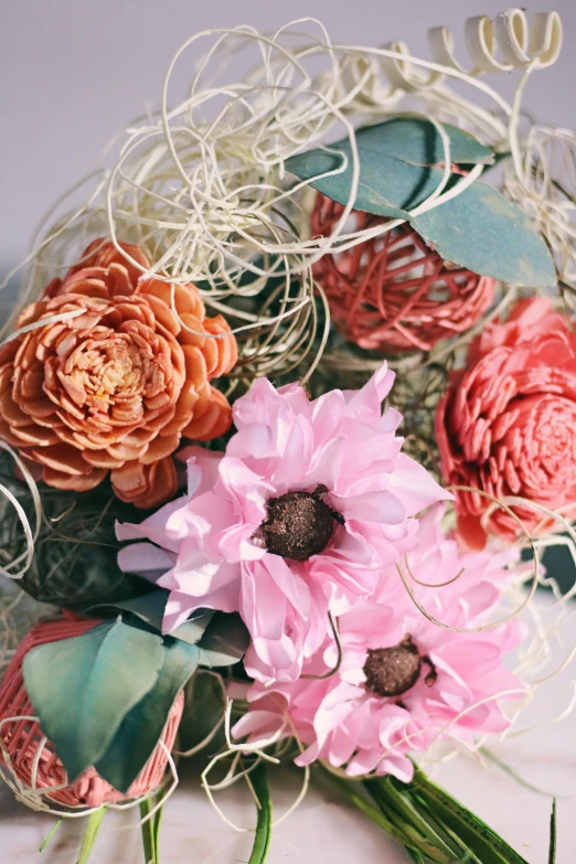 a bouquet of flowers sitting on top of a table, handcrafted paper background, wicker art, insanely details, dahlias